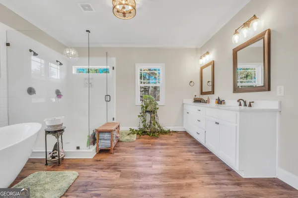 a spacious bathroom with a tub sink and a window