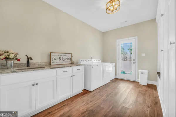 a utility room with cabinets washer and dryer
