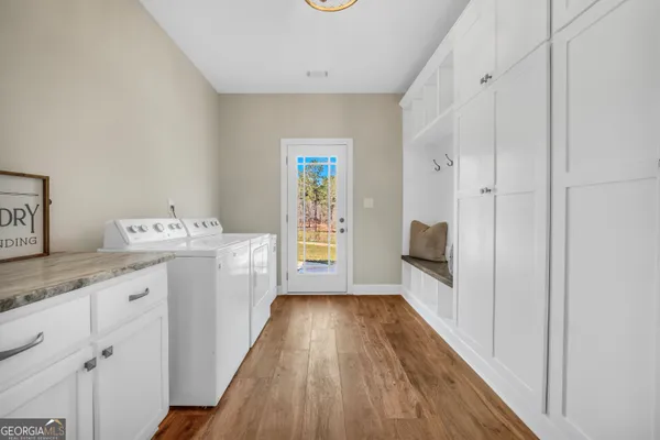 a view of entryway with furniture and wooden floor