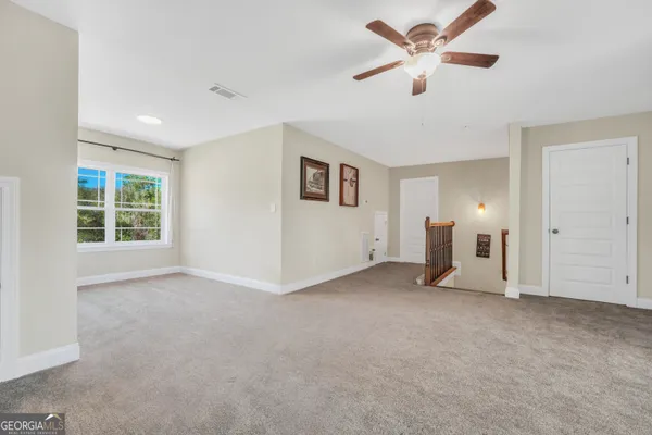 a living room with furniture a chandelier and a large window