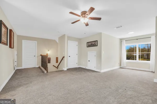 a living room with patio fireplace furniture and a floor to ceiling window