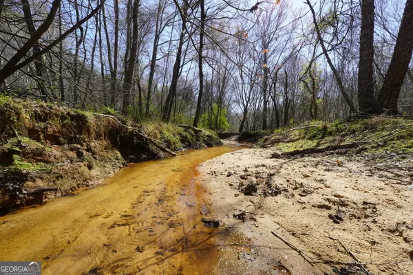 a swimming pool with trees in the background
