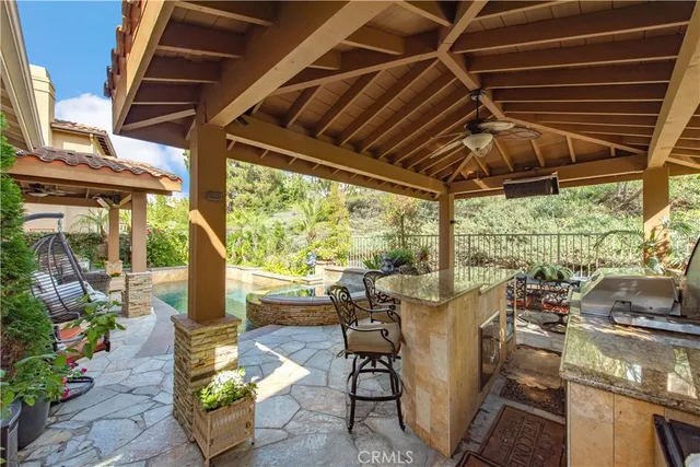 a view of a patio with table and chairs and potted plants