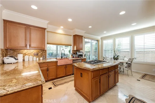 a kitchen with stainless steel appliances granite countertop sink stove and refrigerator