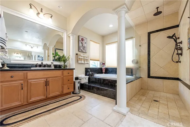 a spacious bathroom with a sink a mirror and a bathtub
