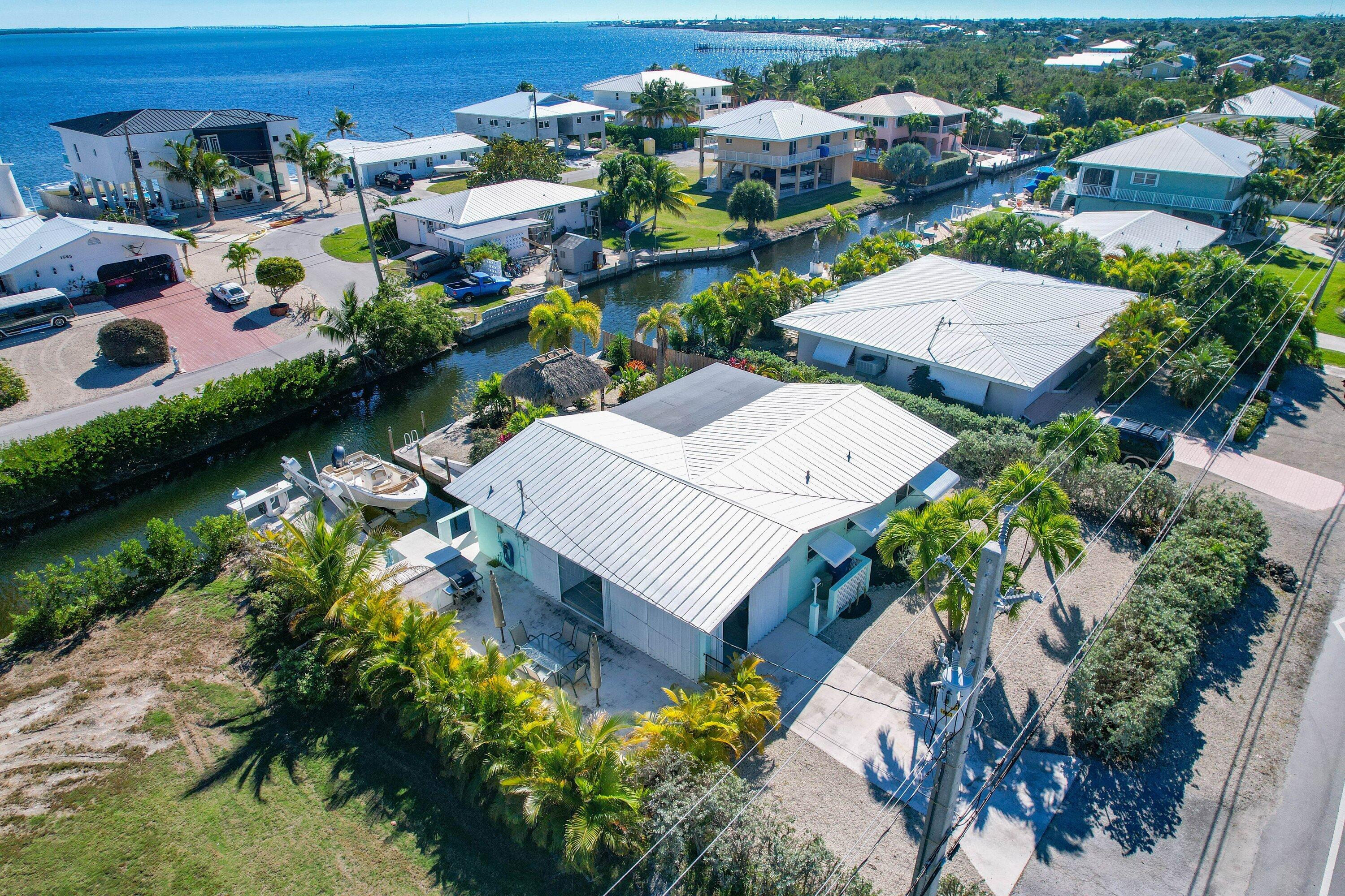 1567 Watson Boulevard Big Pine Key, FL 33043 - Photo 1 of 57 an aerial view of a house with a garden and lake view