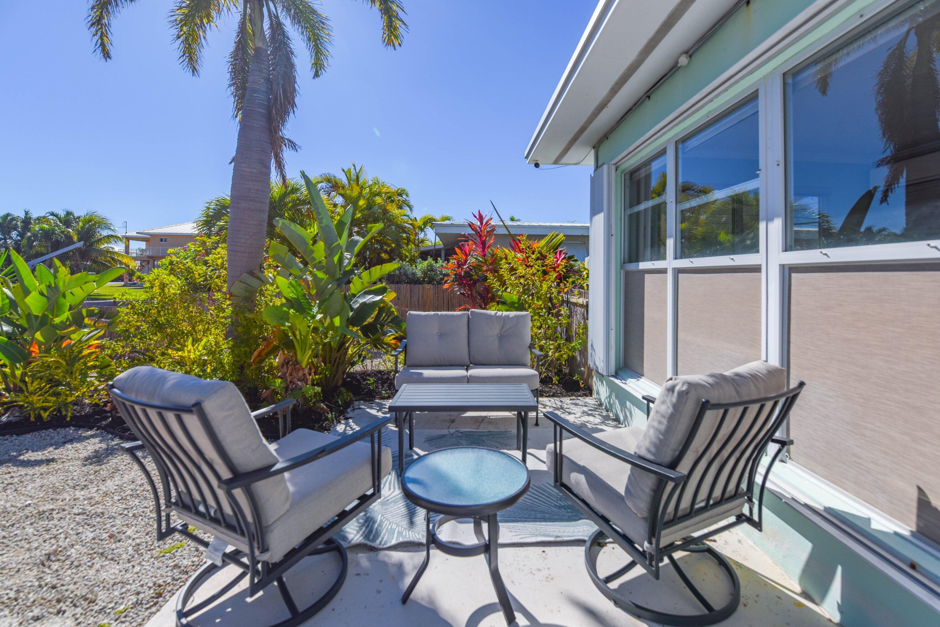 1567 Watson Boulevard Big Pine Key, FL 33043 - Photo 29 of 57 a outdoor living space with furniture and a potted plant