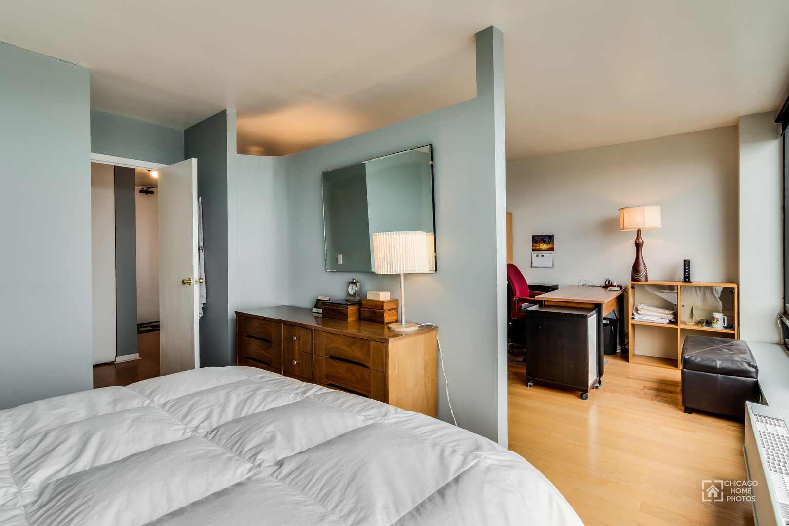 5445 North Sheridan Road, Unit 1809 Chicago, IL 60640 - Photo 13 of 18 a bedroom with a bed and a dresser