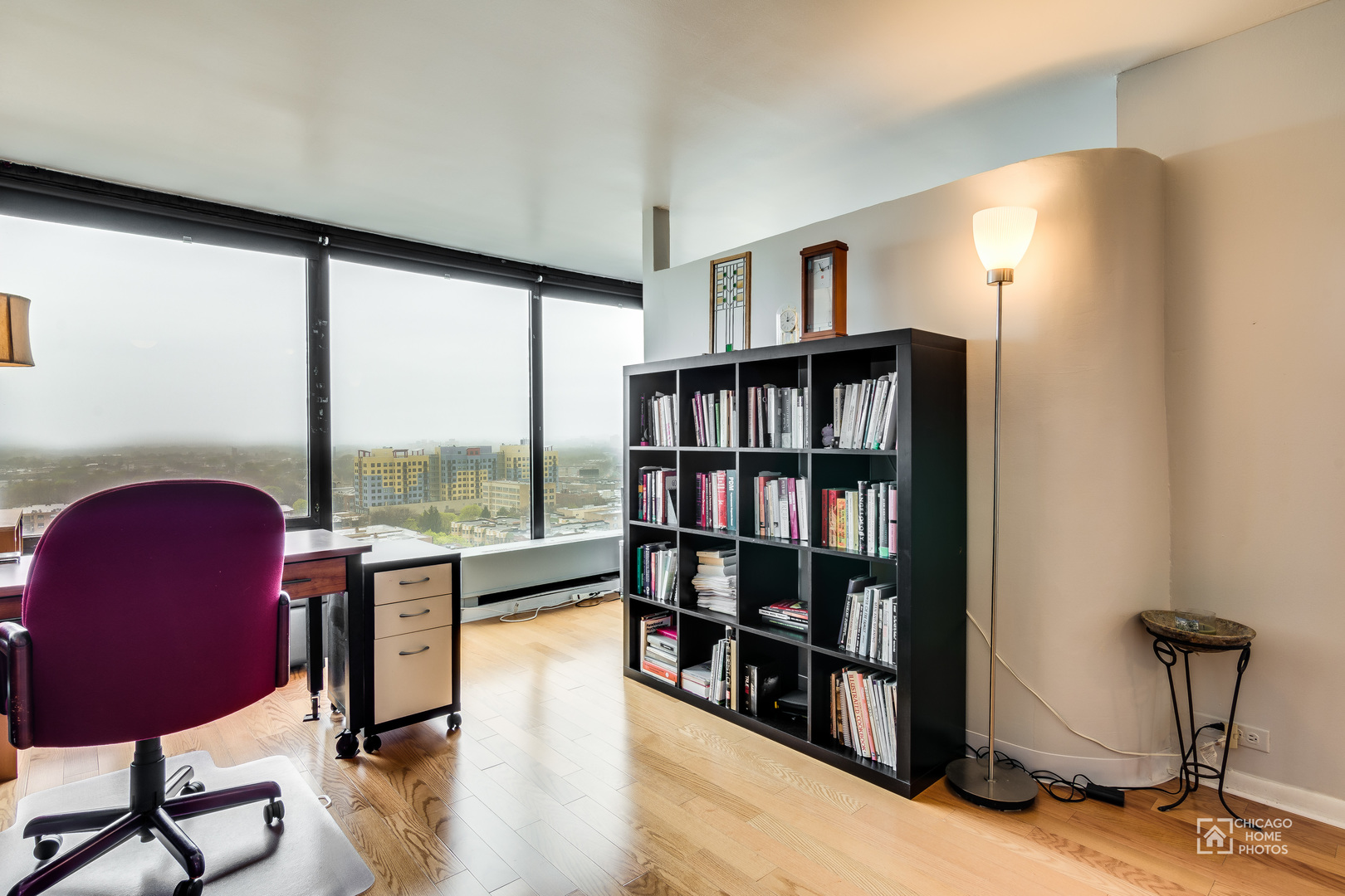 5445 North Sheridan Road, Unit 1809 Chicago, IL 60640 - Photo 3 of 18 a living room with furniture and a book shelf