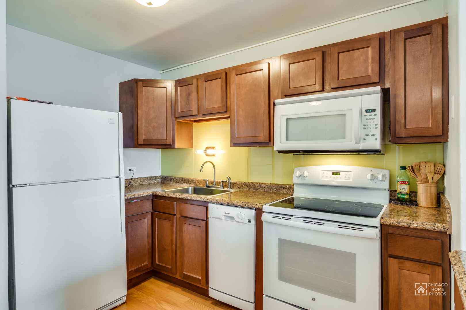 5445 North Sheridan Road, Unit 1809 Chicago, IL 60640 - Photo 6 of 18 a kitchen with a stove sink and refrigerator