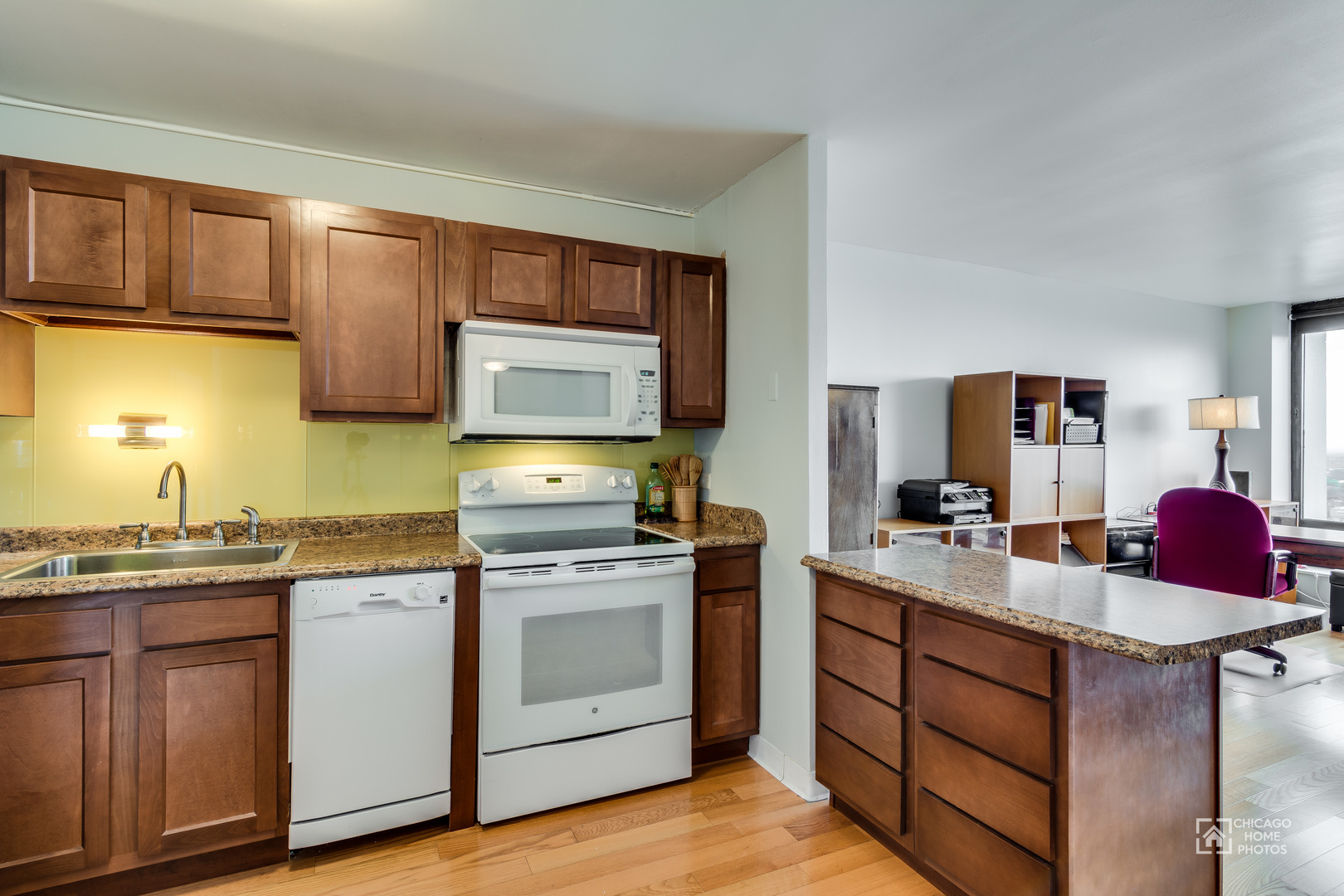 5445 North Sheridan Road, Unit 1809 Chicago, IL 60640 - Photo 7 of 18 a kitchen with a sink stove top oven and cabinets