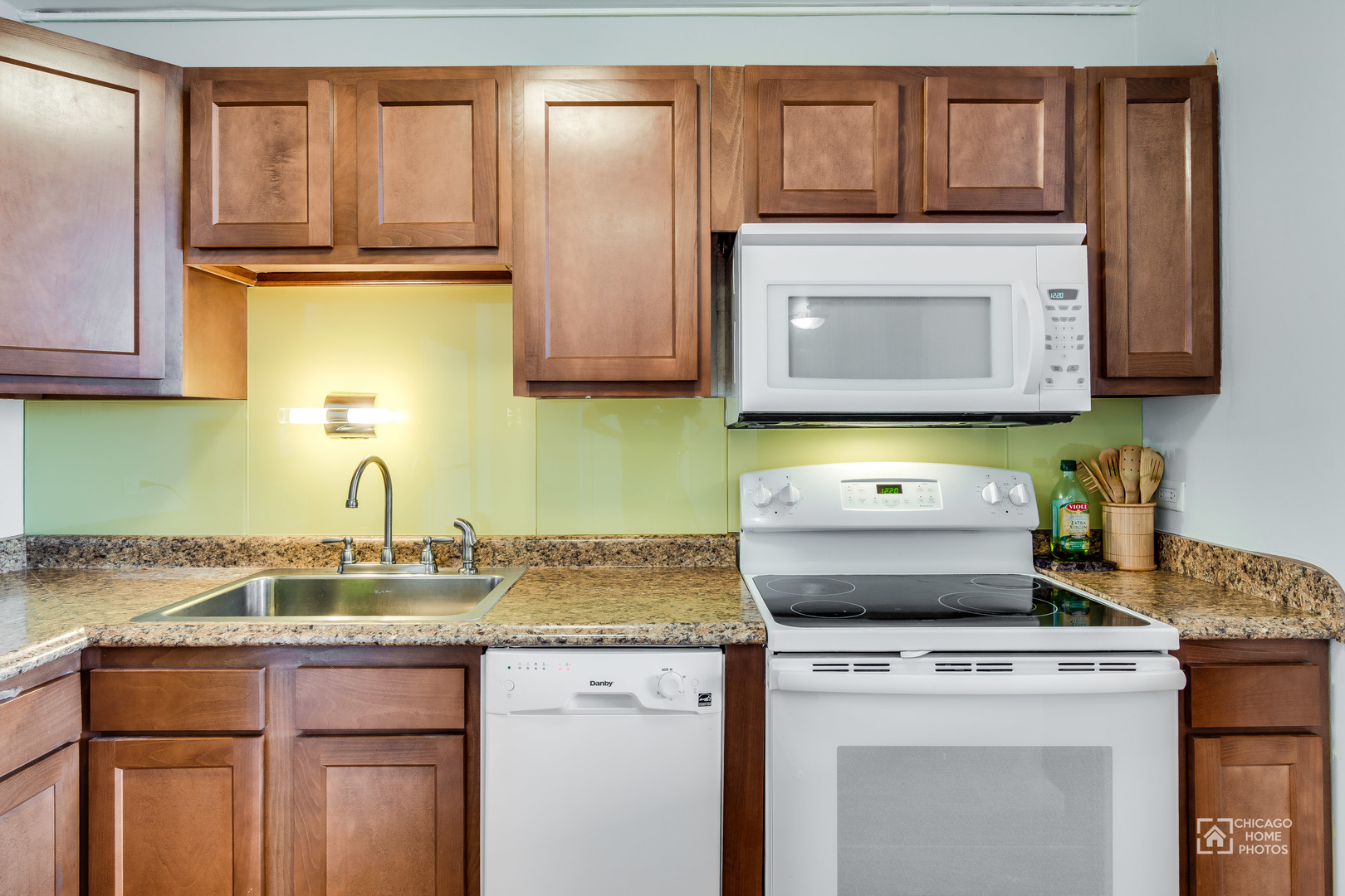 5445 North Sheridan Road, Unit 1809 Chicago, IL 60640 - Photo 8 of 18 a kitchen with granite countertop cabinets stainless steel appliances and a counter space