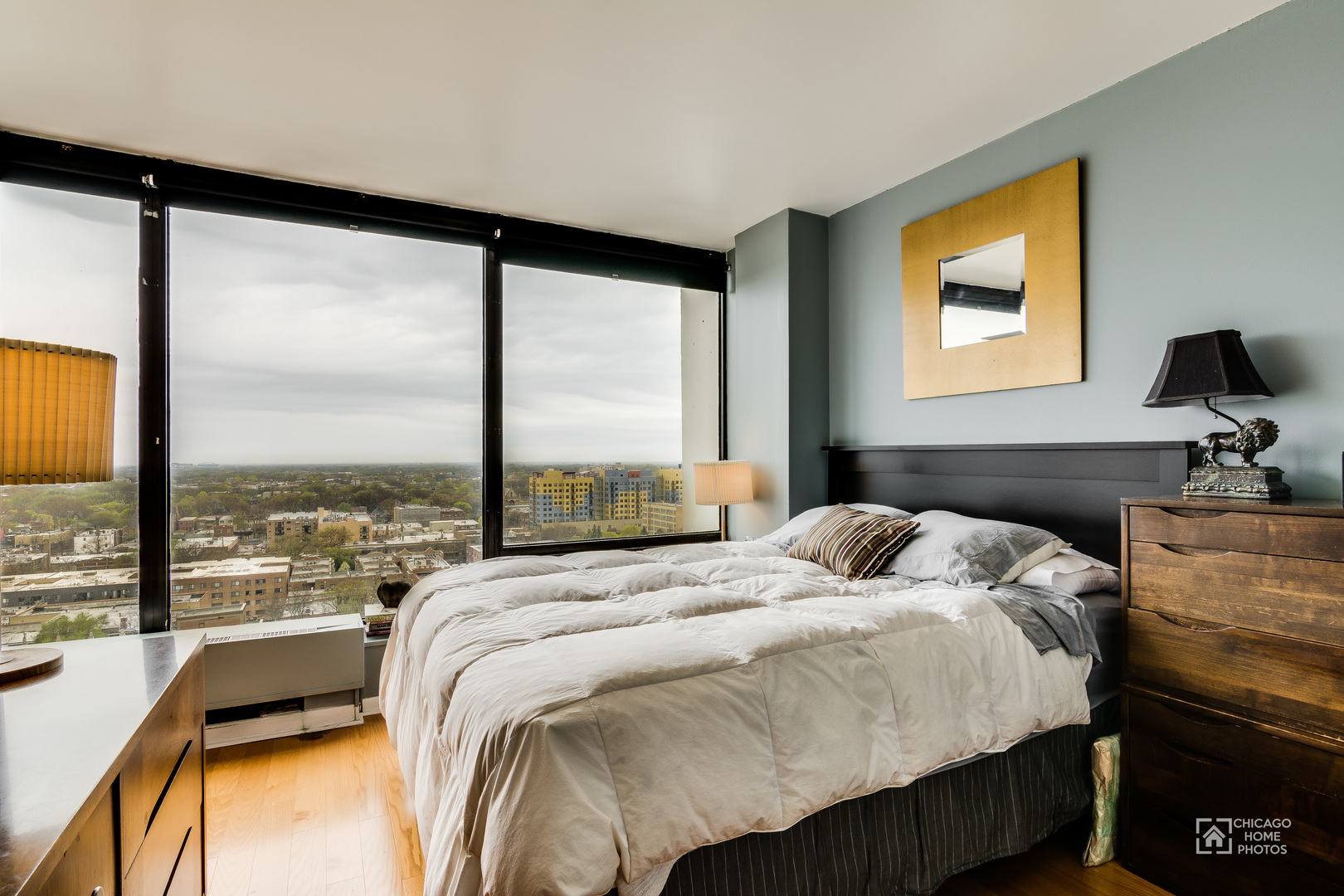 5445 North Sheridan Road, Unit 1809 Chicago, IL 60640 - Photo 10 of 18 a bedroom with a bed and glass window
