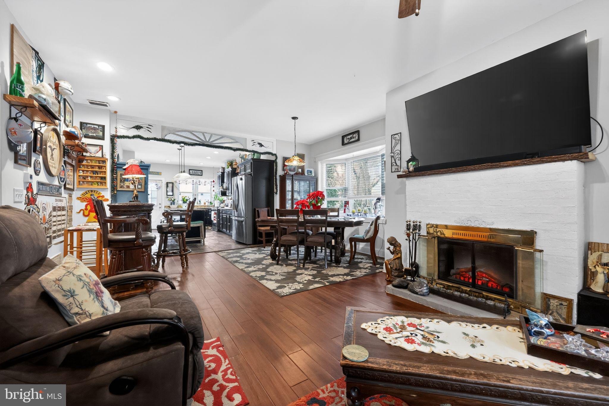 225 Rutland Avenue Mount Holly, NJ 08060 - Photo 6 of 30 a living room with furniture a flat screen tv and a fireplace