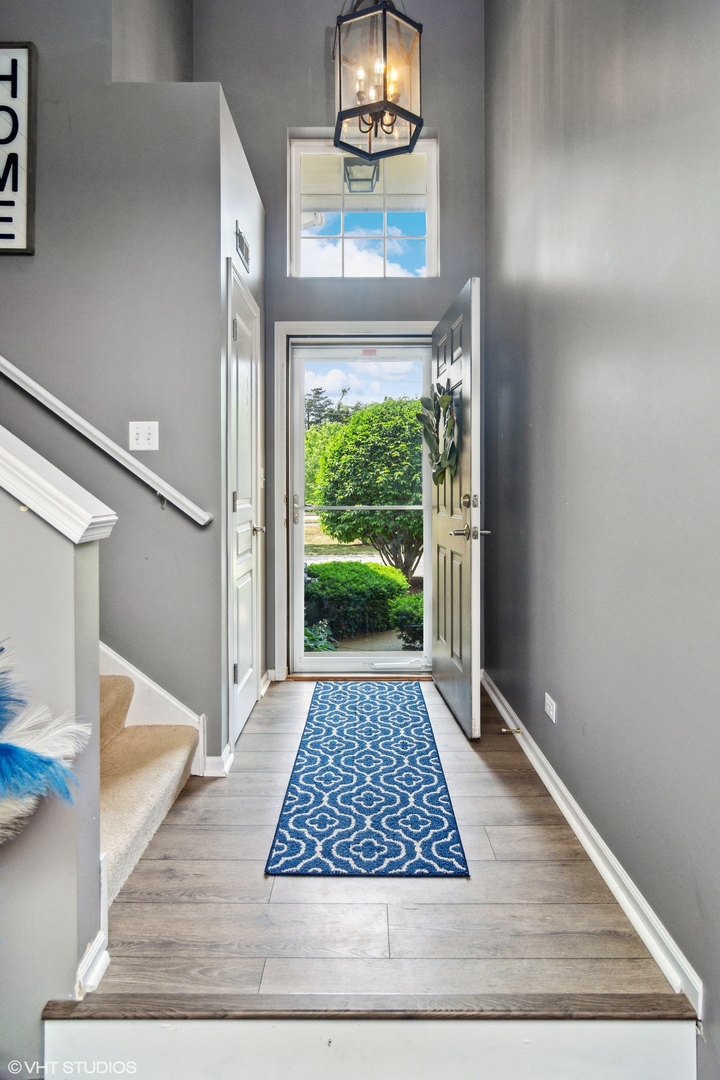 655 Pointe Drive Crystal Lake, IL 60014 - Photo 3 of 22 a view of a hallway view with wooden floor and a rug