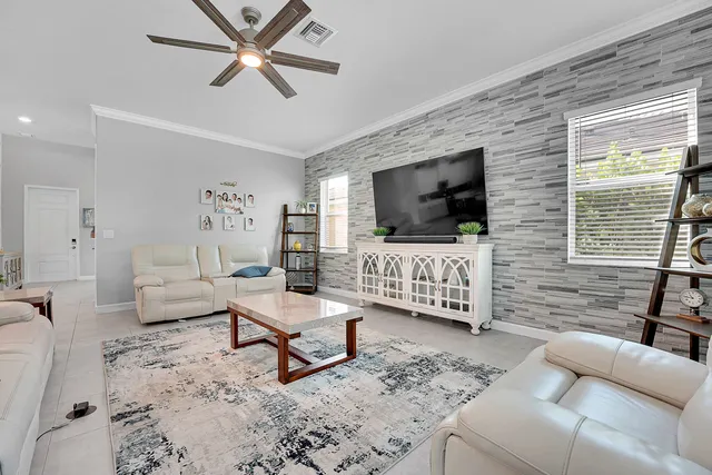 a view of a dining room with furniture large windows and wooden floor