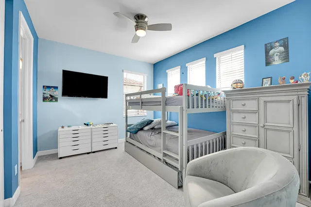 a dining hall with stainless steel appliances granite countertop a stove and a sink