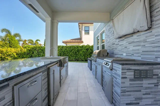 a childrens park with lots of swings slides and swimming pool in the back