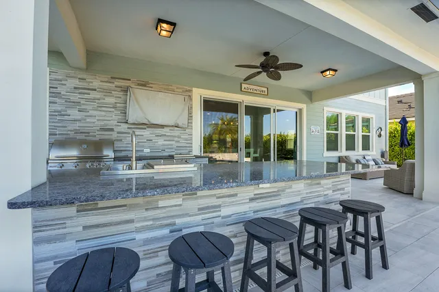 an aerial view of a house with a swimming pool yard and outdoor seating