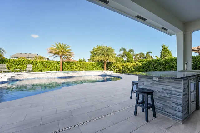a front view of a building with palm trees