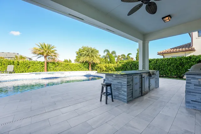 a view of a house with a yard and palm tree