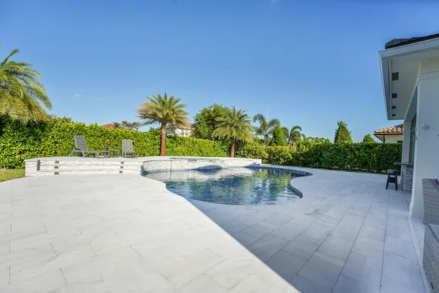 a dining room with furniture and a floor to ceiling window