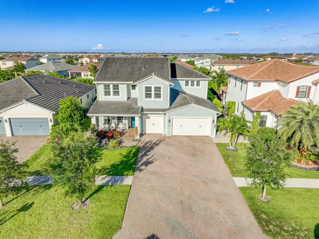 an aerial view of a house with a yard