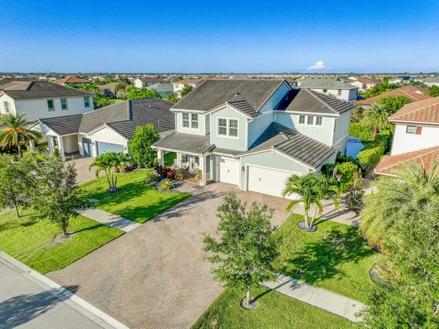 an aerial view of residential houses with yard