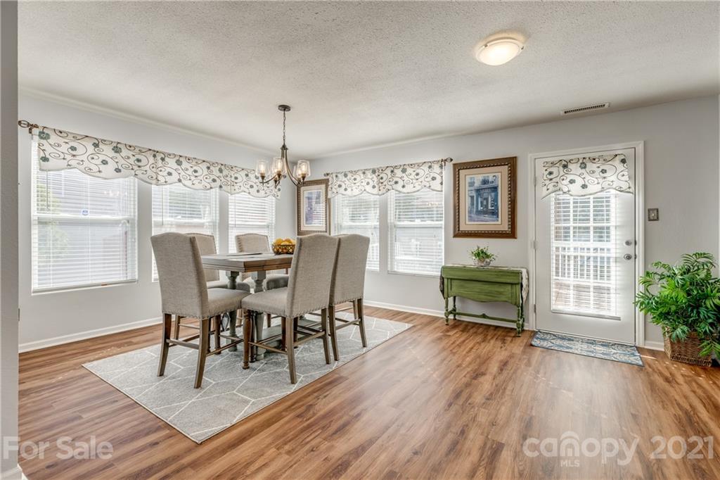 199 Old Carriage Road Clover, SC 29710 - Photo 22 of 48 a view of a dining room with furniture window and wooden floor