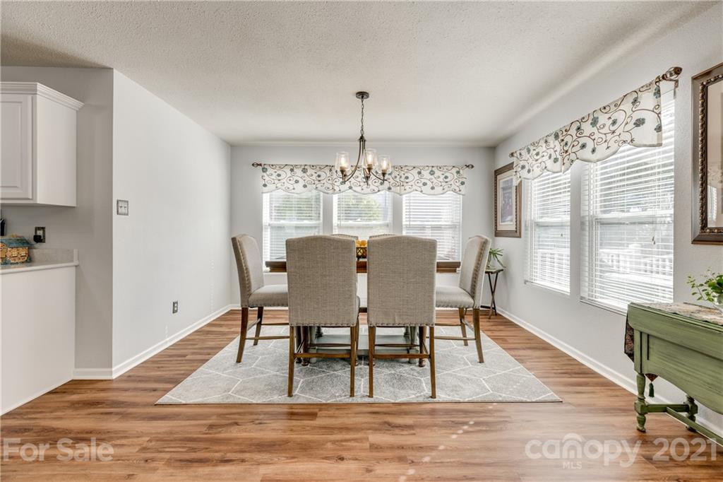 199 Old Carriage Road Clover, SC 29710 - Photo 23 of 48 a view of a dining room with furniture window and wooden floor