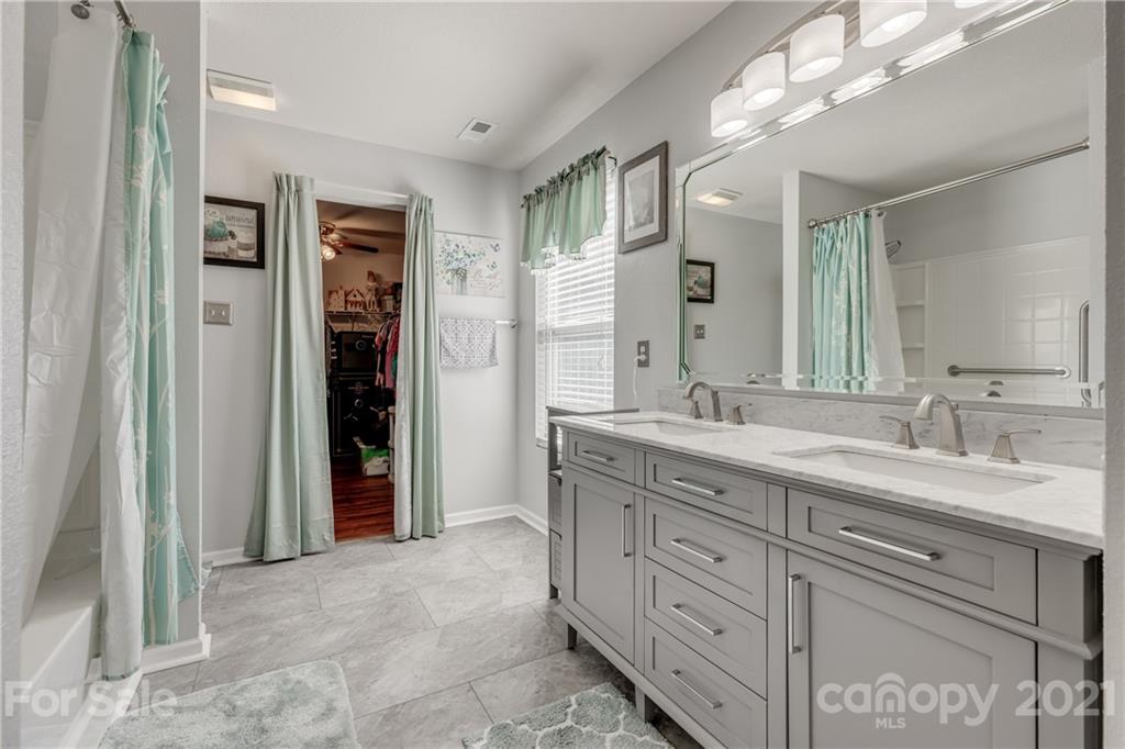 199 Old Carriage Road Clover, SC 29710 - Photo 35 of 48 a spacious bathroom with a granite countertop sink mirror and shower
