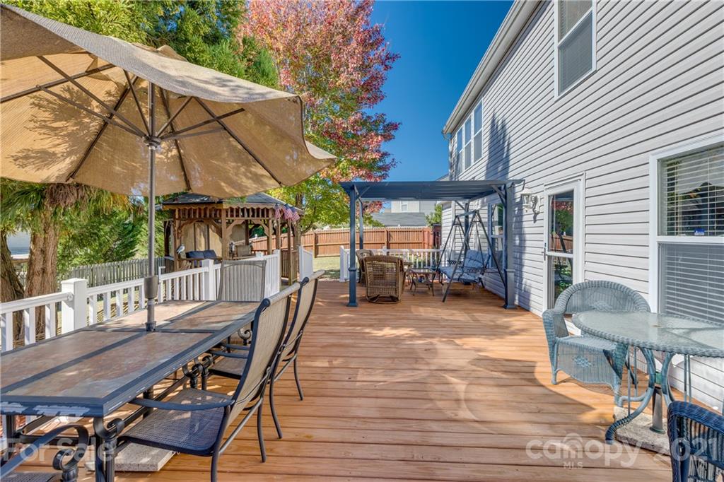 199 Old Carriage Road Clover, SC 29710 - Photo 46 of 48 a view of a patio with a table chairs and a backyard