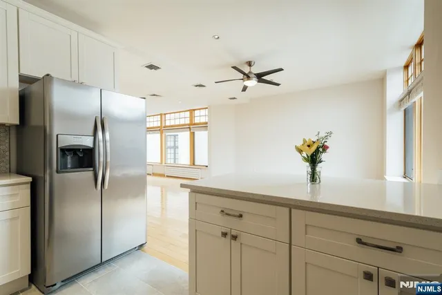 a kitchen with stainless steel appliances a refrigerator and a sink