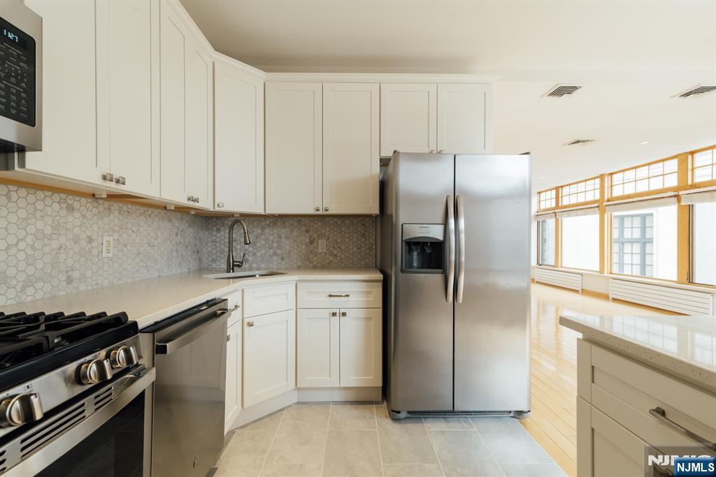 30 Park Avenue, Unit 2 Rutherford, NJ 07070 - Photo 15 of 31 a kitchen with a refrigerator stove and cabinets