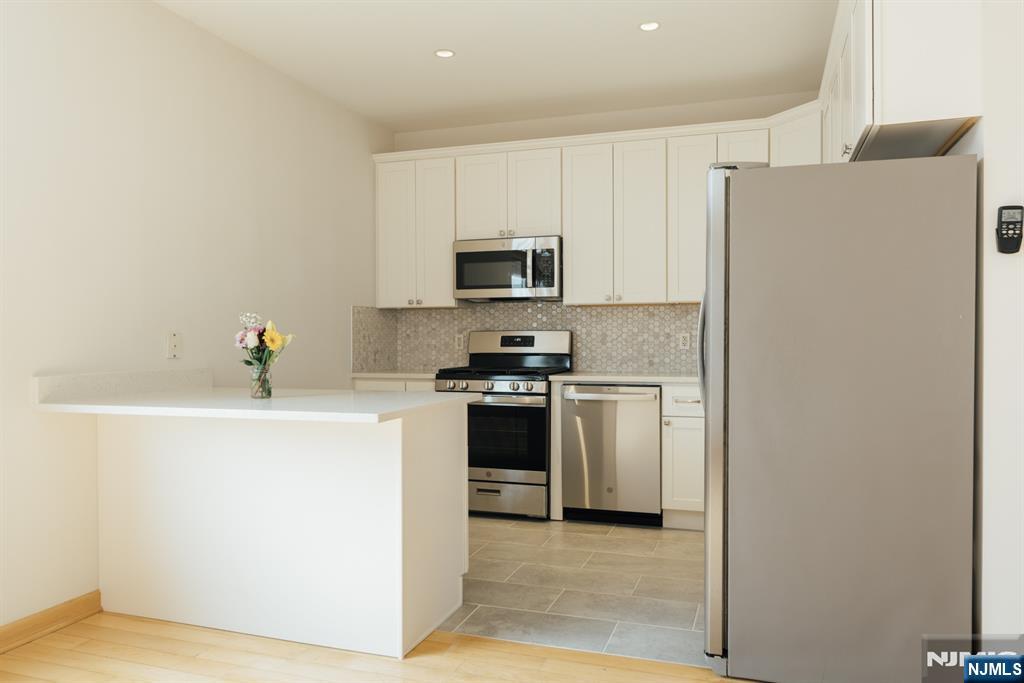 30 Park Avenue, Unit 2 Rutherford, NJ 07070 - Photo 16 of 31 a kitchen with a refrigerator stove and a sink