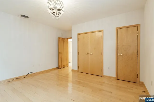 a view of an empty room with closet