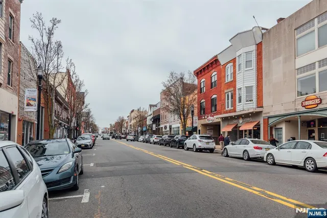 a couple of cars parked in front of a building
