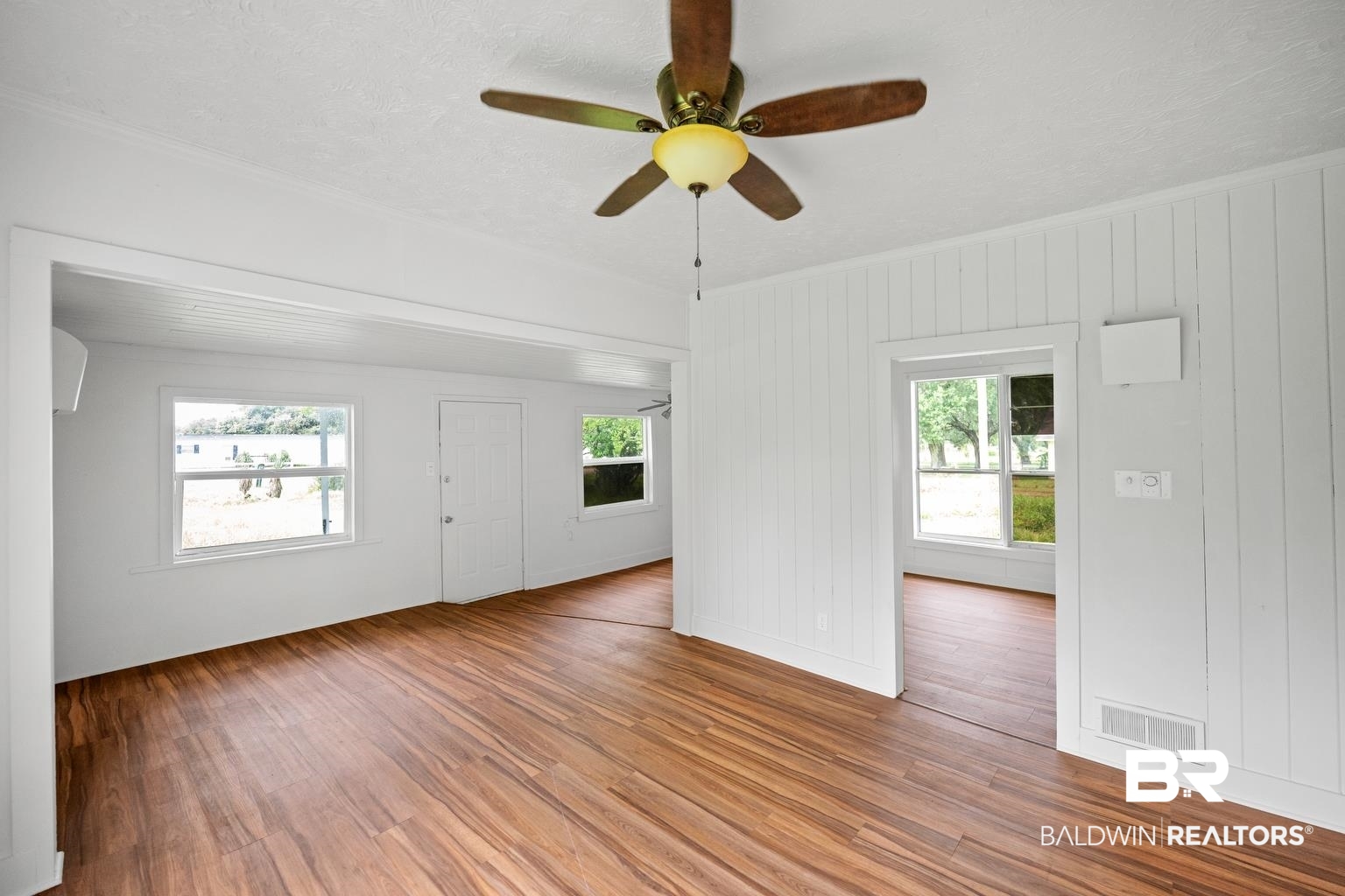 19575 Keller Road Foley, AL 36535 - Photo 8 of 17 Unfurnished living room with plenty of natural light, wood finished floors, a textured ceiling, and a ceiling fan
