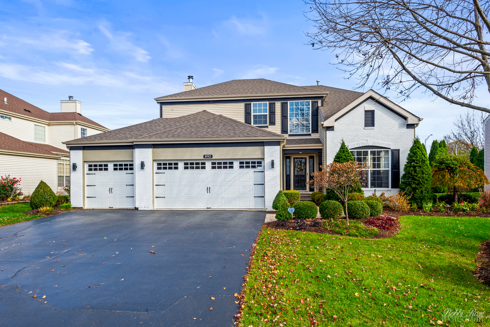 892 Audubon Lane Aurora, IL 60506 - Photo 1 of 53 a front view of a house with a garden and yard