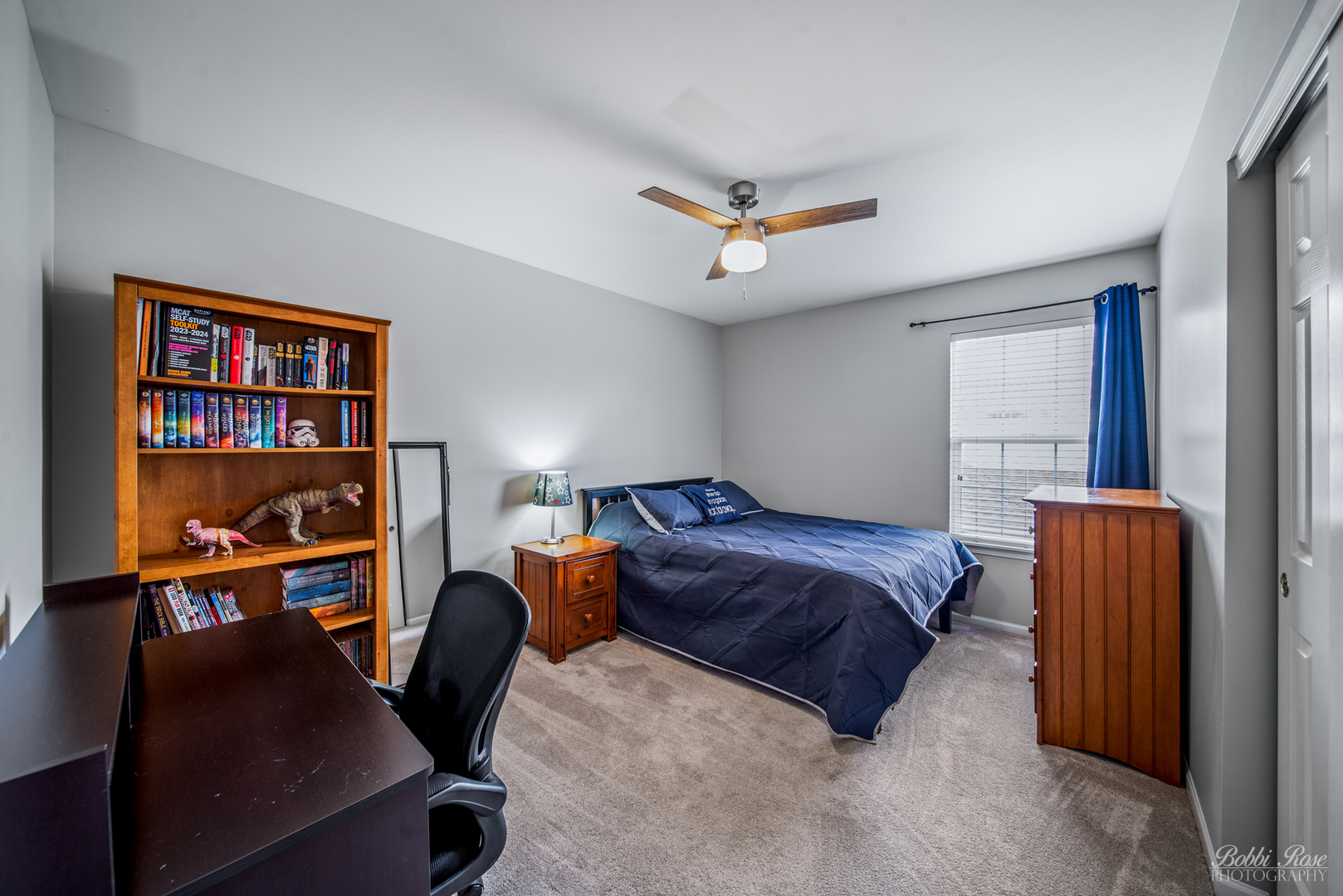 892 Audubon Lane Aurora, IL 60506 - Photo 29 of 53 a spacious bedroom with a bed a dresser and a book shelf