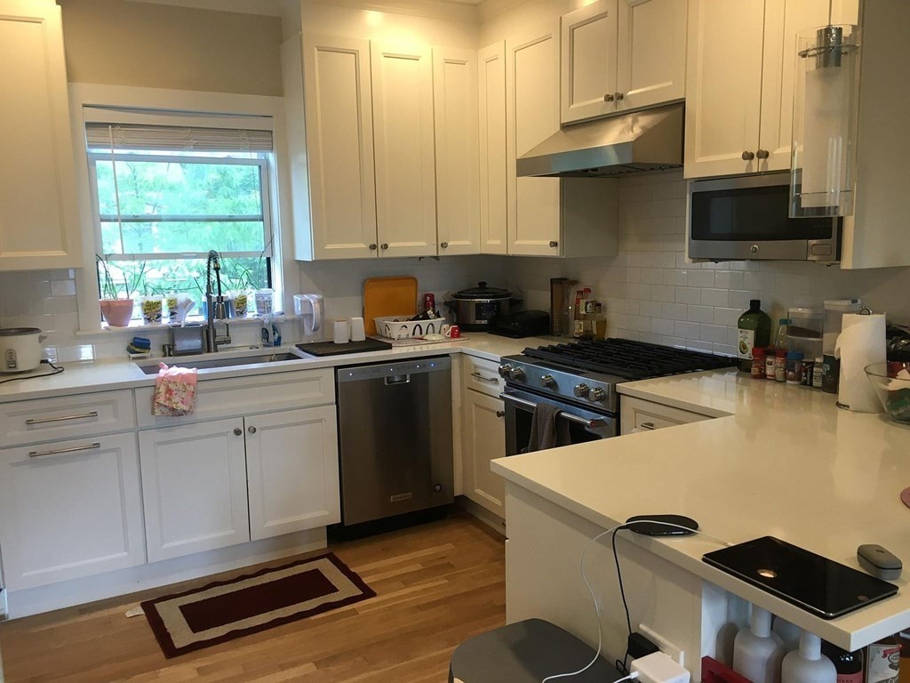 a kitchen with a sink a stove and cabinets