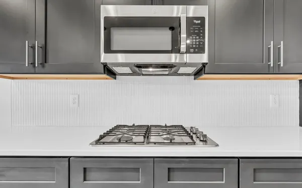 a stove sitting inside of a kitchen