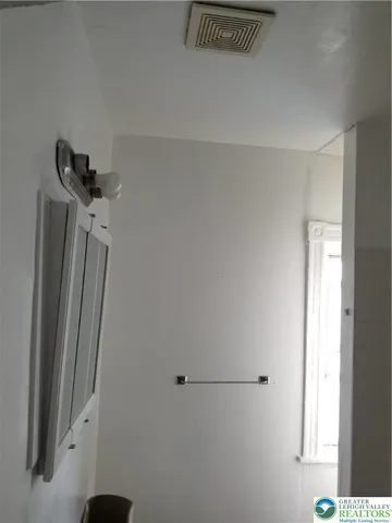 a bathroom with a shower and a window