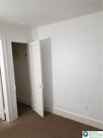 a room with cabinet and mirror