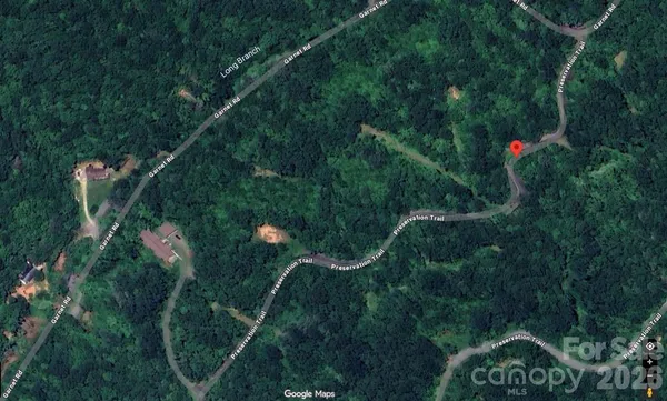 a view of a house with a park and trees