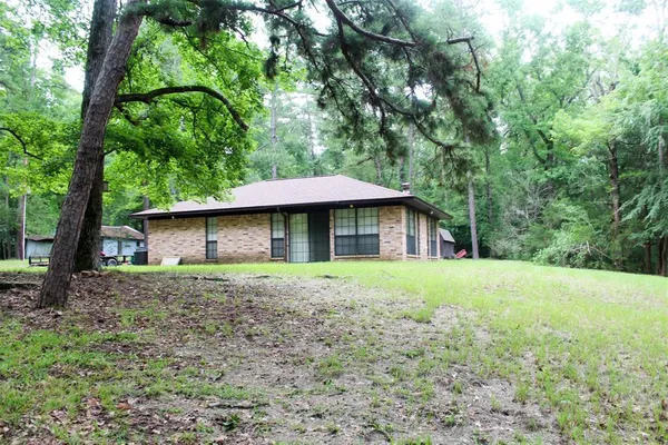 a view of a house with large trees