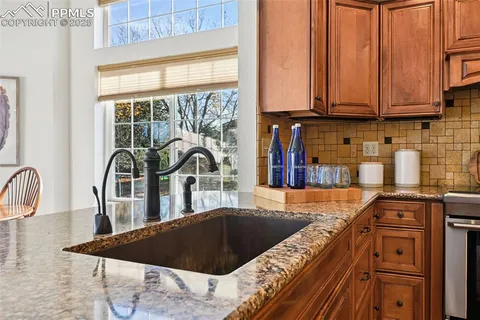 a kitchen with a stove a sink and a microwave