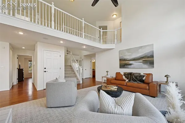 a living room with furniture wooden floor and a fireplace