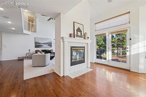 a living room with furniture wooden floor and a fireplace