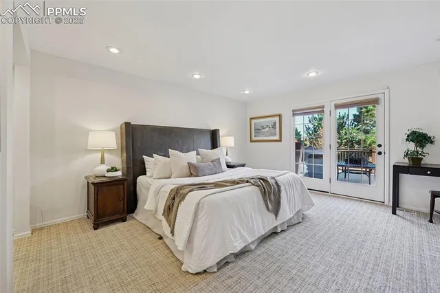 a spacious bedroom with a large bed and a large window